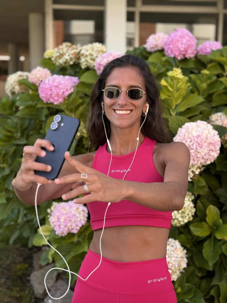 Mujer usando el top basico de Pratyque con compresión alta, en un paseo por el jardin
